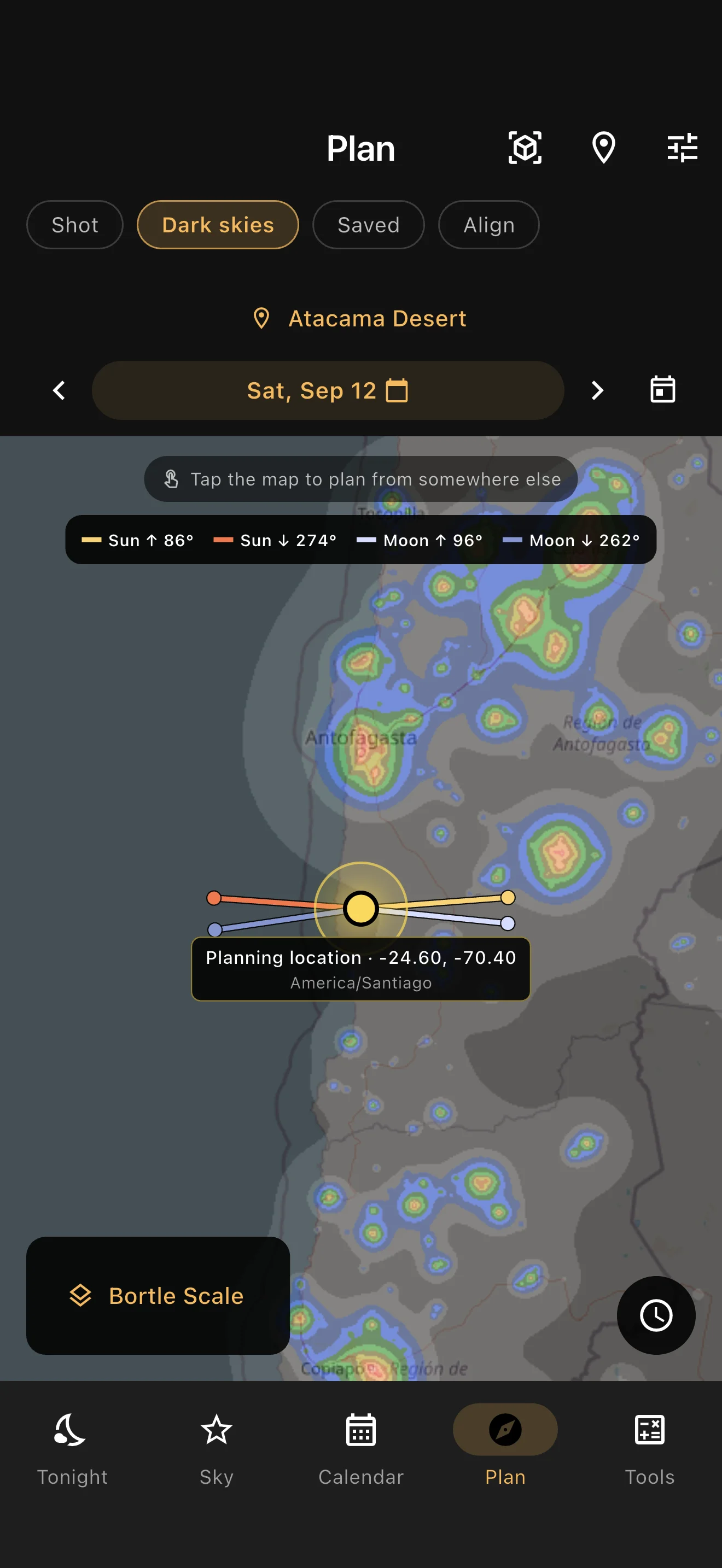 Dark-sky map with a light pollution overlay, planning location and Sun and Moon direction lines.